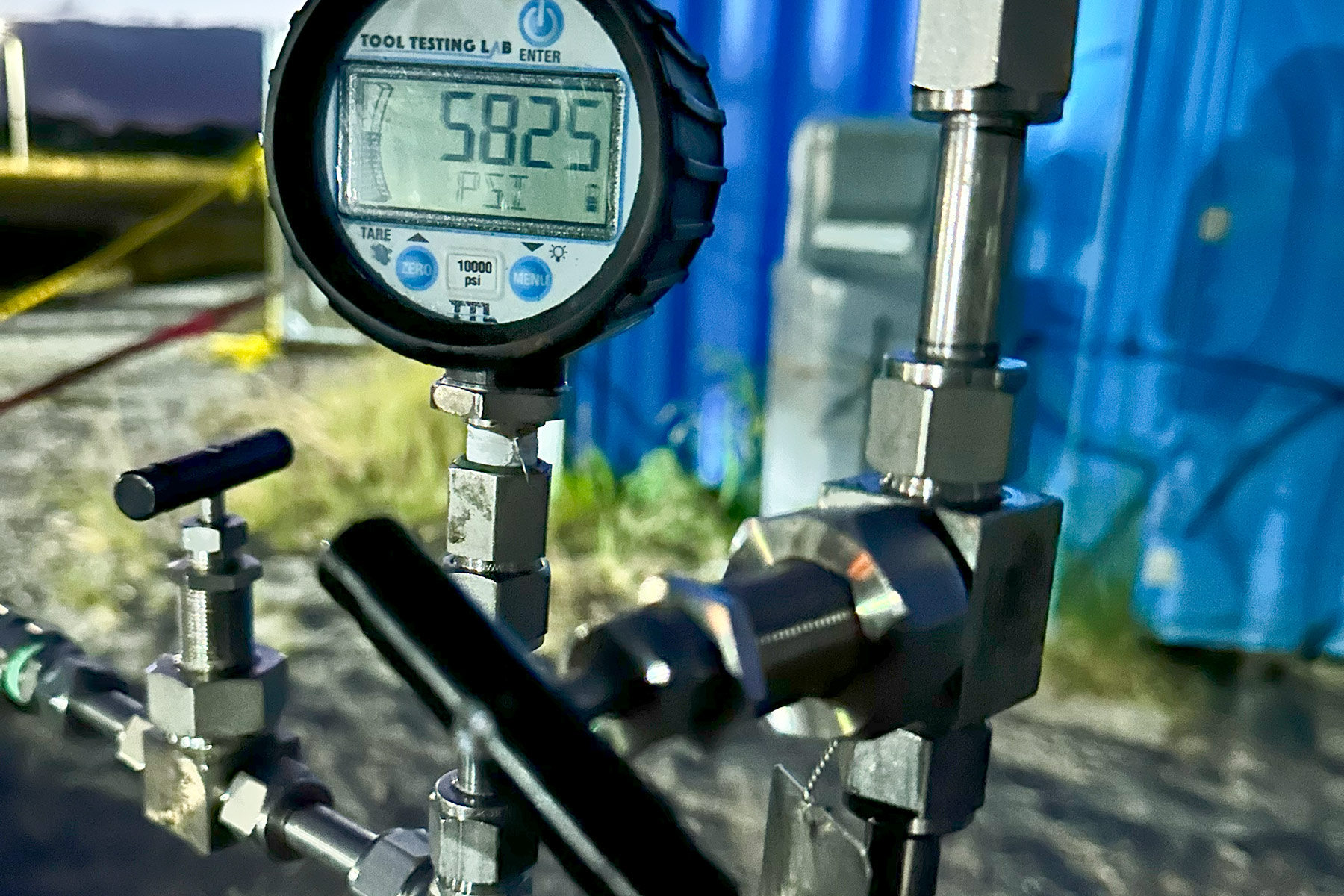 Close-up of a digital pressure gauge reading over 5800 psi, connected to stainless steel fittings and valves—illustrating high-pressure testing and monitoring in Steelhead’s hydrogen storage systems.